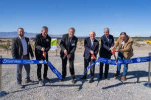 Image of Vice Chair George Tyson cutting a ribbon with others at the Yellow Pine solar site