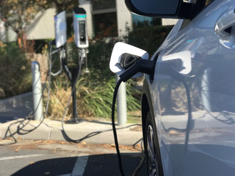 image of electric car plugged into charger