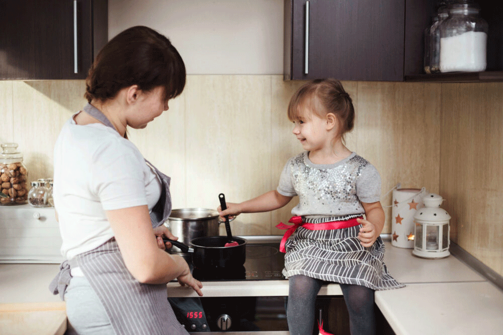 mom and daughter cooking